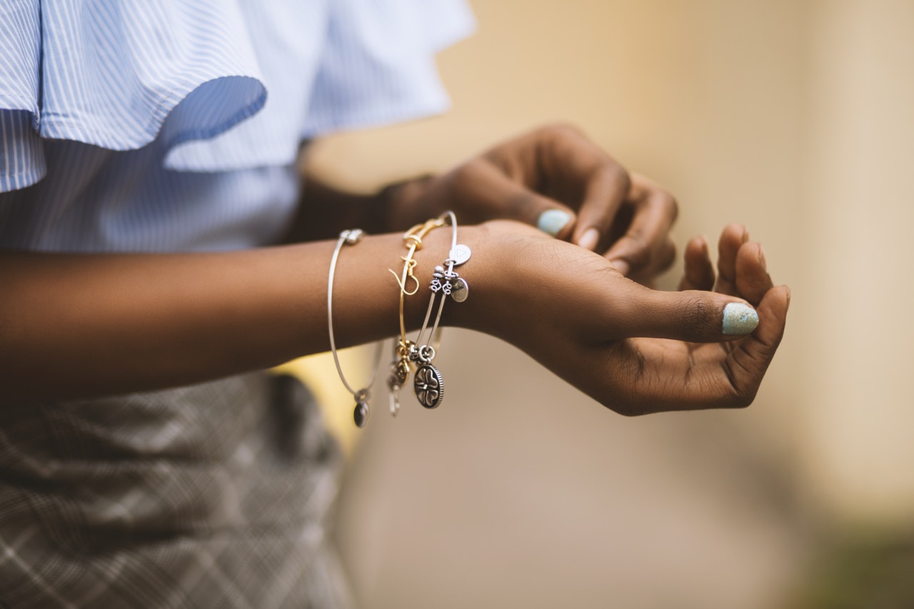 selective-focus-photography-of-person-wearing-three-bangles