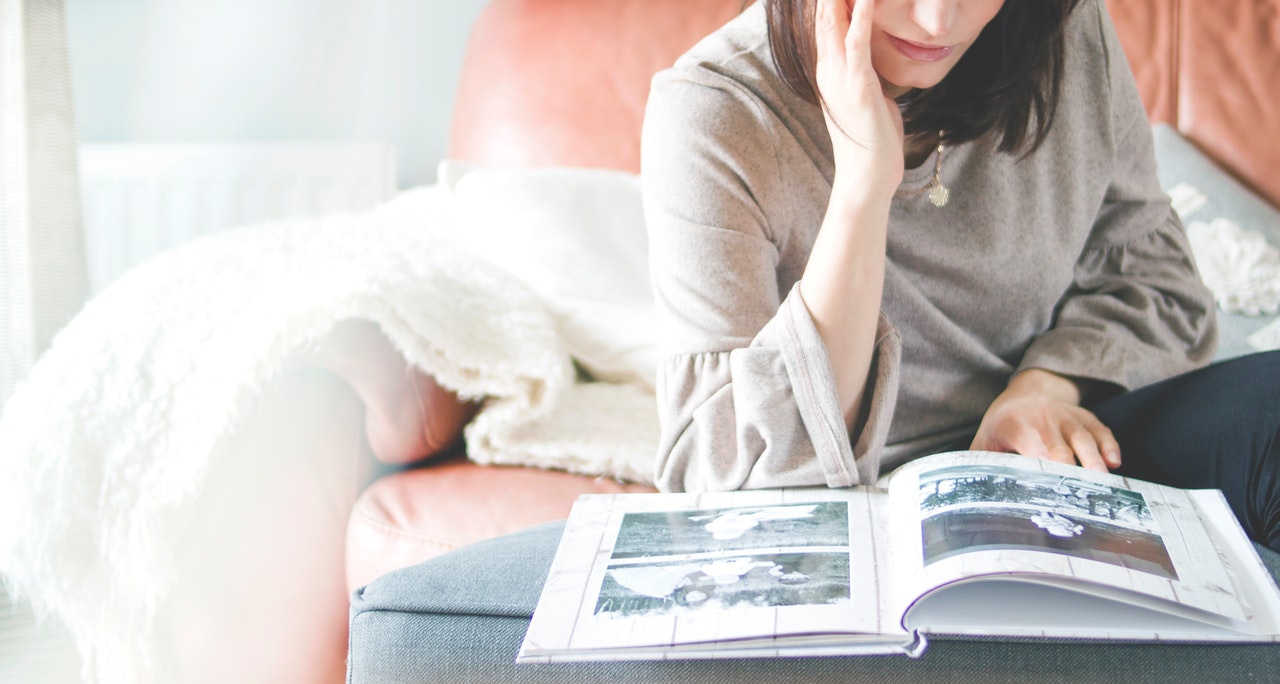 woman-looking-at-photo-album