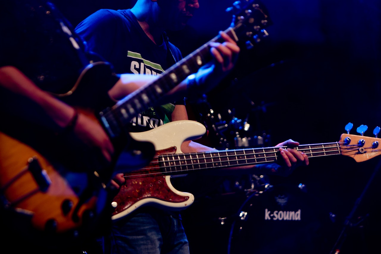 photo-of-people-playing-electric-guitars