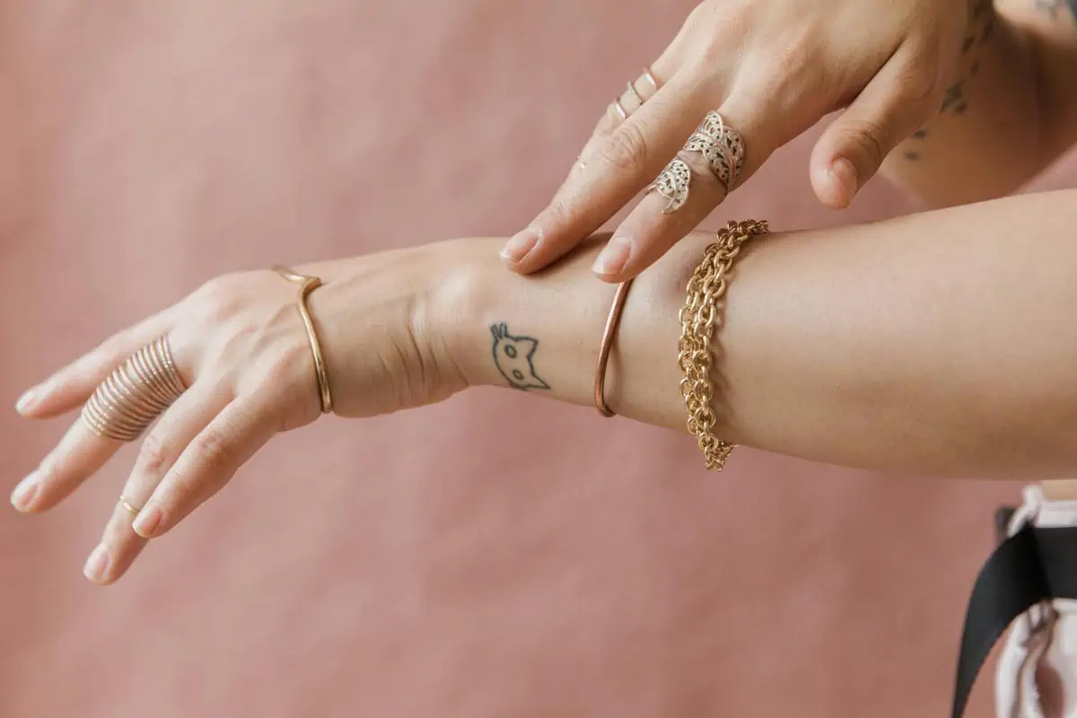 close-up-shot-of-a-person-wearing-gold-jewelries-52825